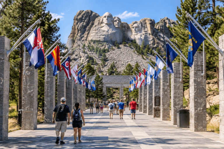 Visitors walking along the Avenue of Flags during a Mount Rushmore tour